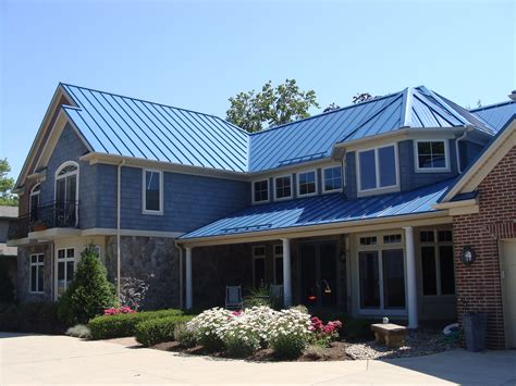 stucco house with blue metal roof|blue metal roof house exterior.